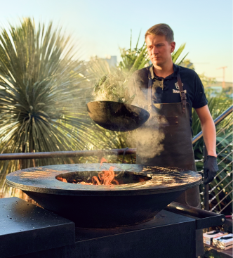 Chef cooking live over fire for an event